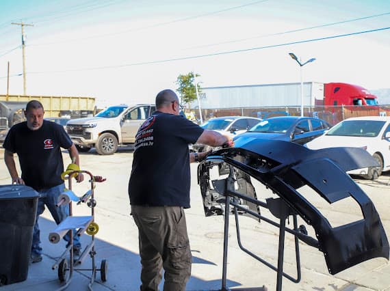 Auto body technician working on vehicle outdoors in Las Vegas Nevada